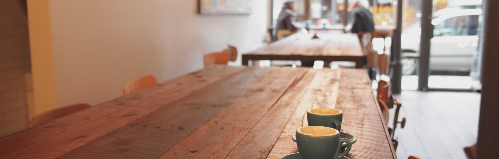 A quiet cafe with a long wooden table